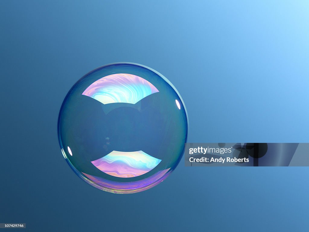 Bubble floating against blue background