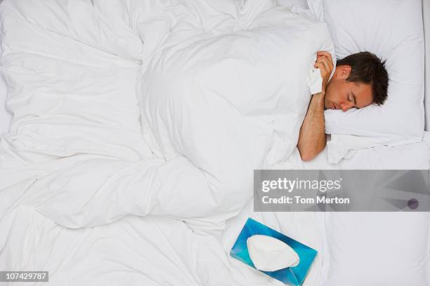 kranken mann schlafen im bett - above view of man sleeping on bed stock-fotos und bilder