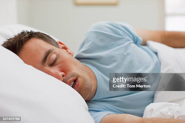 sick man sleeping in bed - 張開嘴 個照片及圖片檔