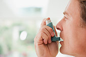 Man about to use asthma inhaler