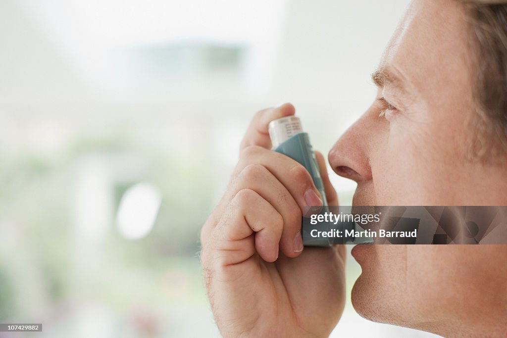 Man about to use asthma inhaler