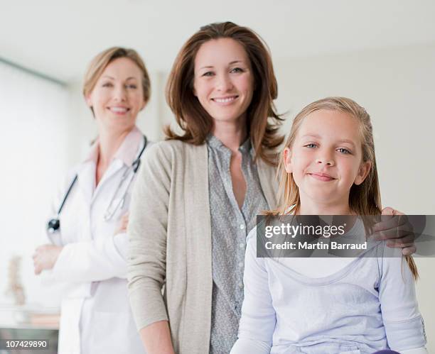 doctor, mother and daughter in doctors office - three female doctors stock pictures, royalty-free photos & images