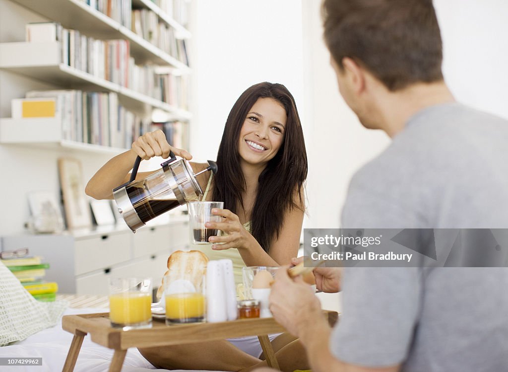 Couple having breakfast in bed