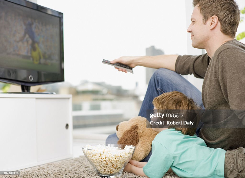 Father and son watching television