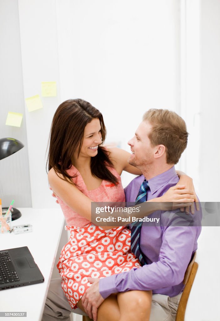 Woman sitting on boyfriends lap