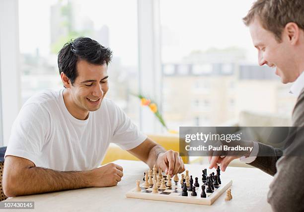 friends playing chess together - chess stock pictures, royalty-free photos & images