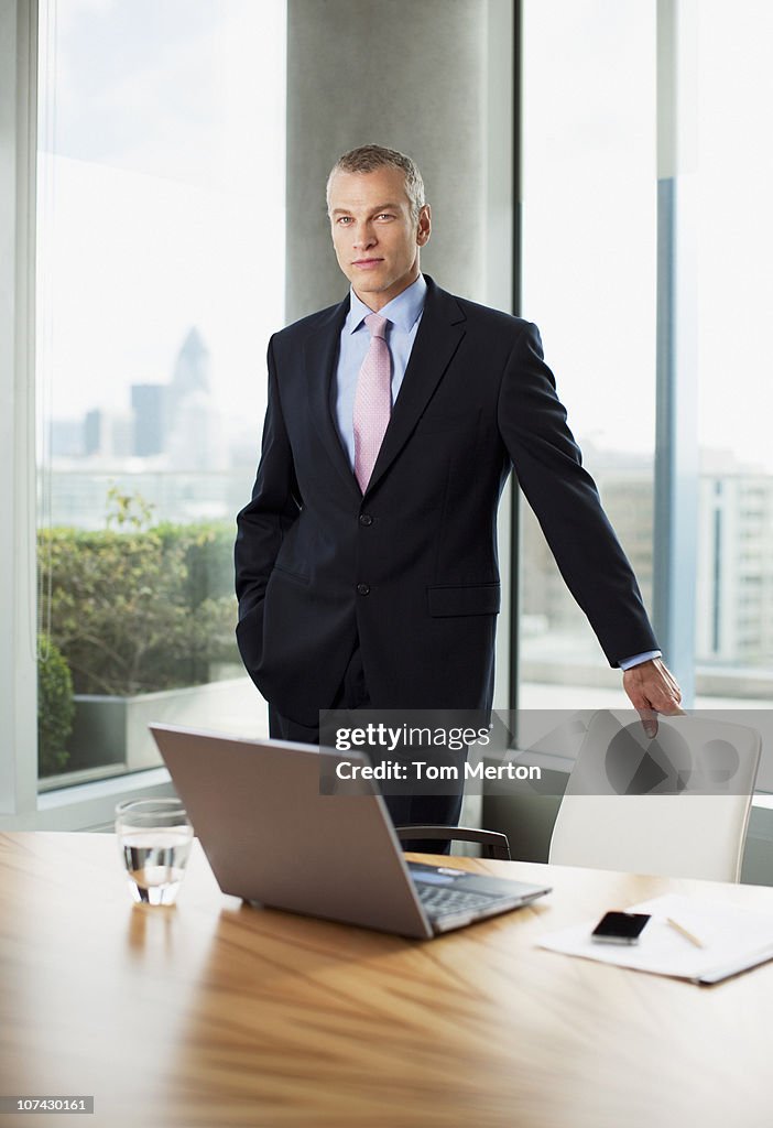 Businessman standing at desk in office