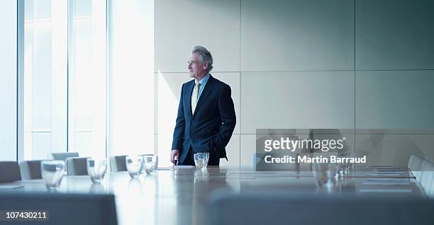 uomo d'affari in piedi da solo in sala conferenze - chief executive officer foto e immagini stock