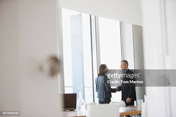business people shaking hands in conference room - happy ending bildbanksfoton och bilder