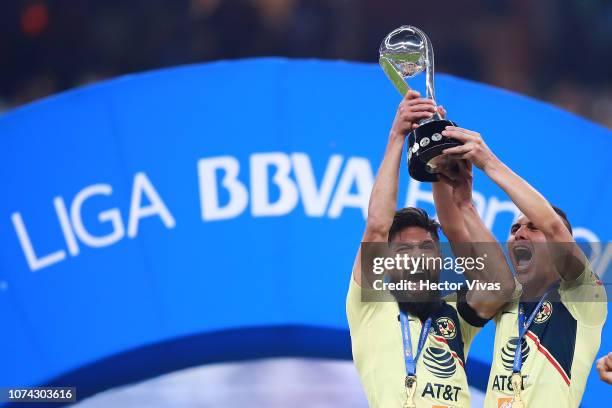 Oribe Peralta and Paul Aguilar of America lift the Championship Trophy after the final second leg match between Cruz Azul and America as part of the...