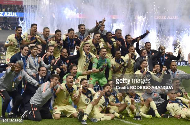 America's players celebrate after defeating Cruz Azul to win the Mexican Apertura Tournament football final at the Azteca stadium in Mexico City, on...