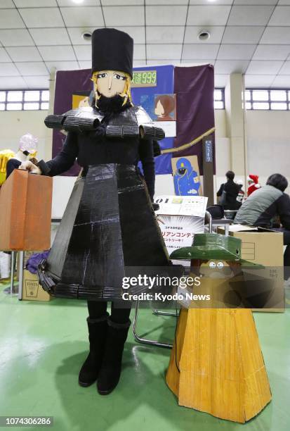 Person wearing a cardboard costume resembling anime character Maetel participates in Cardboard Cosplay Festival in Aomori, northern Japan, on Dec....