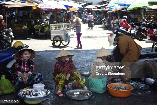 Motorcyclist speaks to a fish vendor at the Duong Dong market in Phu Quoc, Vietnam, on Friday, Nov. 2, 2018. Gourmands are making pilgrimages toRed...