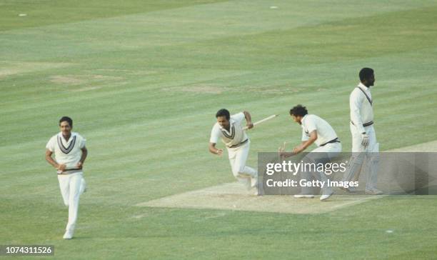 Victorious India players Yaspal Sharma and Roger Binny grab souvinir stumps as Mohinder Amarnath runs off the field as West Indies batsman Michael...