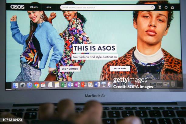 Woman is seen shopping on ASOS the online fashion store on a laptop. Shares in Asos tumbled nearly 40 per cent on Monday morning after the online...