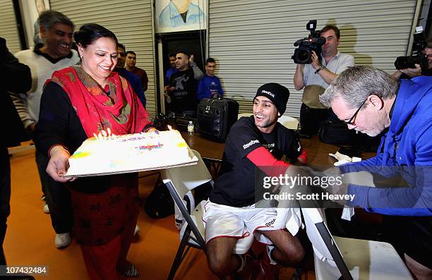 Amir Khan is presented with a birthday cake by his Mum Falak Khan and Dad Shajaad Khan during his open workout at IBA gym on December 8, 2010 in Las...