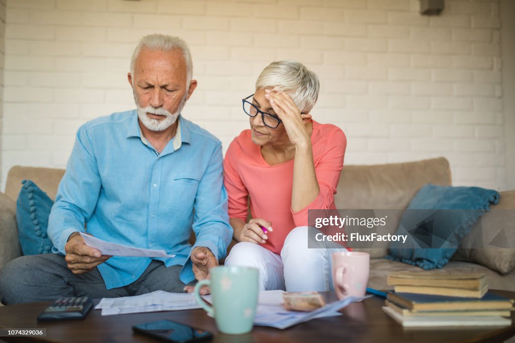Senior couple brainstorming the solution to a financial problem