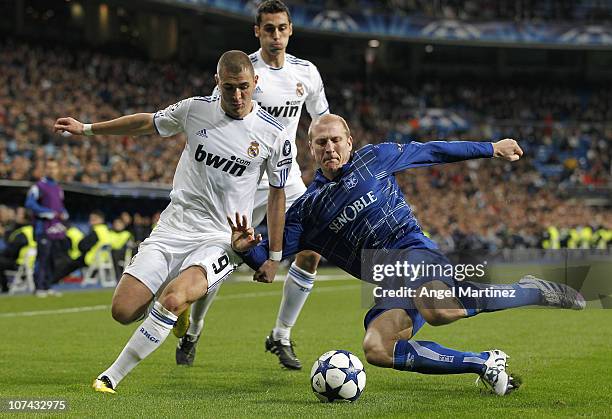 Karim Benzema of Real Madrid fights for the ball with Stephane Grichting of AJ Auxerre during the Champions League group G match between Real Madrid...