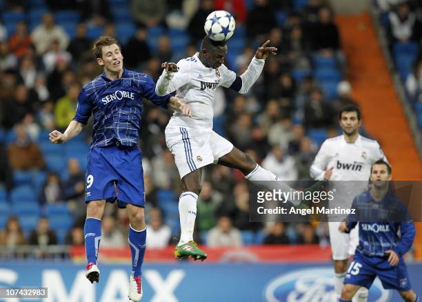 Mahamadou Diarra of Real Madrid jumps for a high ball with Valter Birsa of AJ Auxerre during the Champions League group G match between Real Madrid...