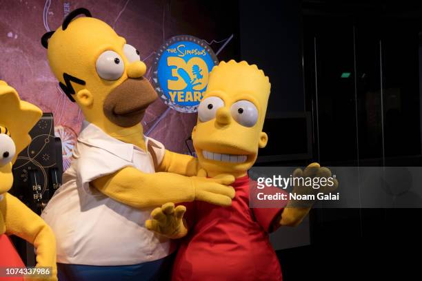 Homer Simpson and Bart Simpson visit The Empire State Building to celebrate the 30th anniversary of "The Simpsons" at The Empire State Building on...