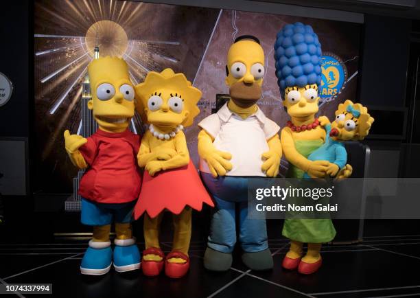 Bart Simpson, Lisa Simpson, Homer Simpson, Marge Simpson and Maggie Simpson visit The Empire State Building to celebrate the 30th anniversary of "The...