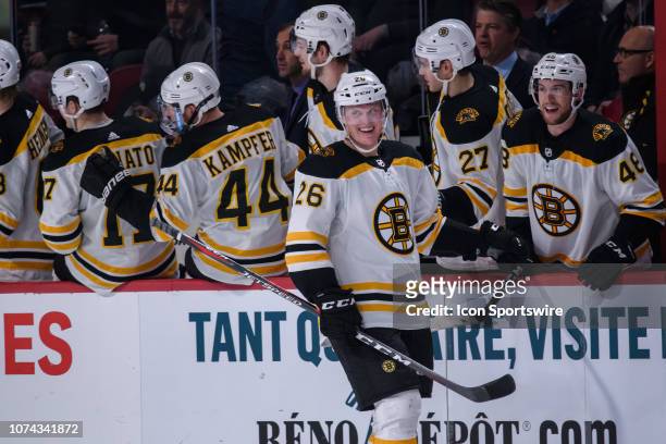Boston Bruins center Colby Cave celebrates with teammates during the second period of the NHL game between the Boston Bruins and the Montreal...