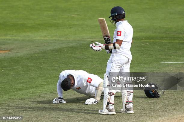 Angelo Mathews of Sri Lanka celebrates his century with a set of push-ups while Kusal Mendis looks on during day four of the First Test match in the...