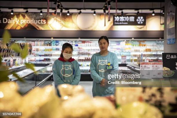 Employees stand inside an Alibaba Group Holding Ltd. Hema store during a government-organized tour in Hangzhou, China, on Wednesday, Dec. 12, 2018....