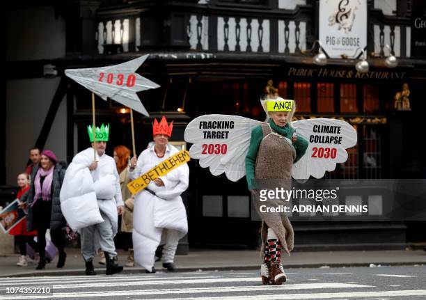 British fashion designer Vivienne Westwood , dressed as an angel, poses with other anti-fracking activists, dressed as Joseph, and the three wise...