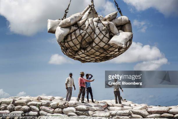 Bloomberg Best of the Year 2018: Dock workers pause while loading sacks by crane onto a cargo ship at Mombasa port, operated by Kenya Ports Authority...