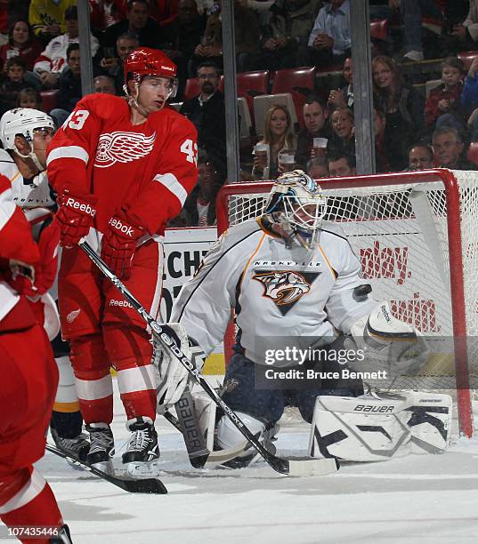 Anders Lindback of the Nashville Predators makes the save as Darren Helm of the Detroit Red Wings waits in front at the Joe Louis Arena on December...