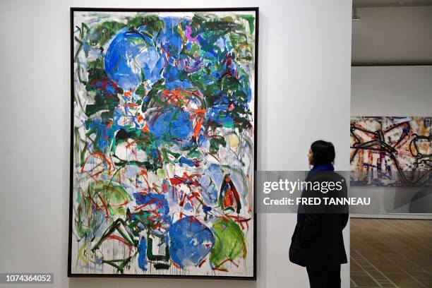 Woman looks at an oil painting "Mon paysage" by US Joan Mitchell during the exhibition "Mitchell-Riopelle, Nothing in moderation" in the Fonds Helene...