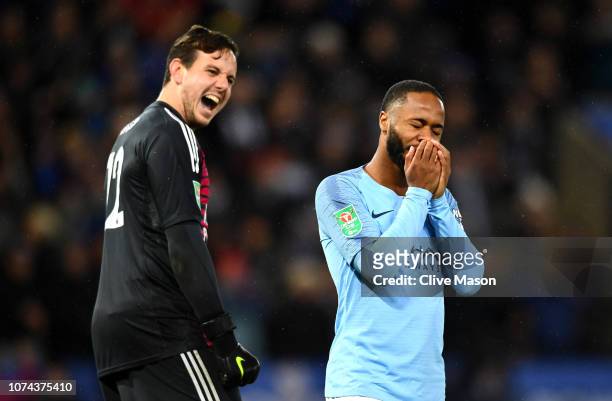 Danny Ward of Leicester City celebrates as Raheem Sterling of Manchester City looks dejected after missing his team's second penalty during a penalty...