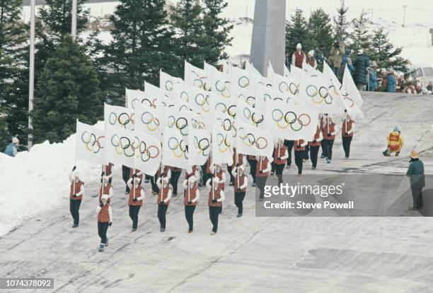 The official Olympic flag bearers arrive at the Opening Ceremony for the XIII Olympic Winter Games on 14 February 1980 at the Lake Placid Equestrian...