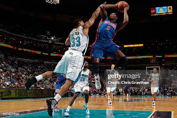 Rodney Stuckey of the Detroit Pistons shoots the ball over Willie Green of the New Orleans Hornets at the New Orleans Arena on December 8, 2010 in...