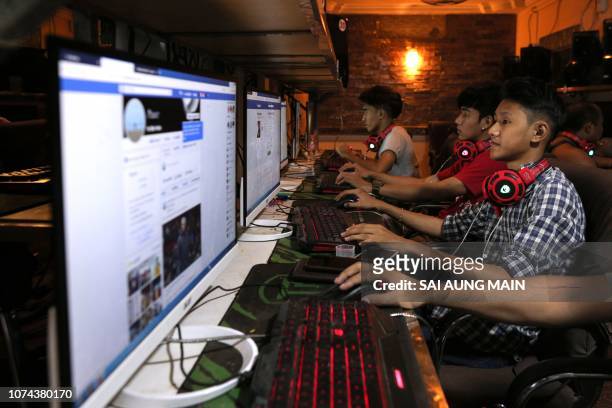 This picture taken on December 18, 2018 shows Myanmar youths browsing their Facebook page at an internet shop in Yangon. - Facebook has removed...