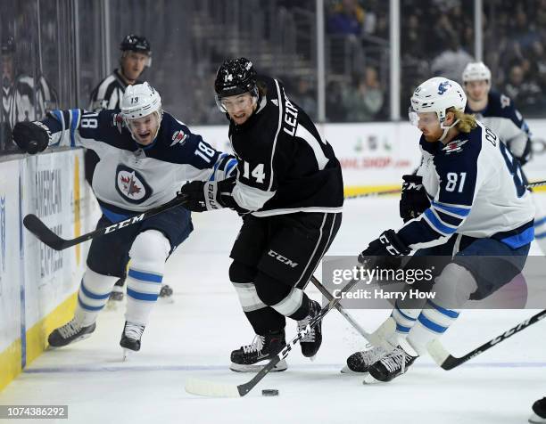 Brendan Leipsic of the Los Angeles Kings chases after the puck between Bryan Little and Kyle Connor of the Winnipeg Jets during the first period at...