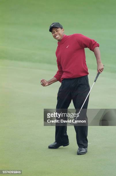 Tiger Woods of the United States celebrates after sinking a 4 feet putt on the 18th green to win the US Masters Golf Tournament with a record low...