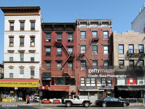 storefronts in the east village in new york city - new york bodega stock pictures, royalty-free photos & images