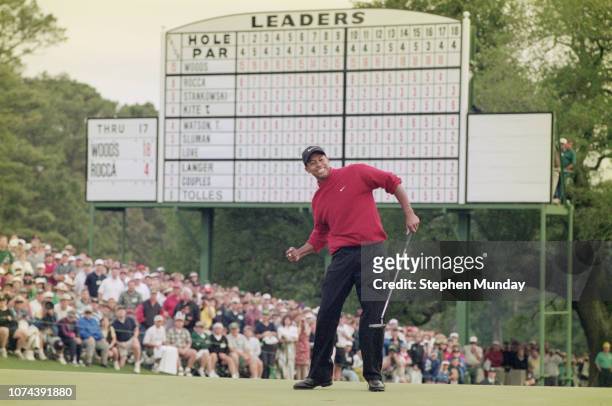 Tiger Woods of the United States celebrates after sinking a 4 feet putt to win the US Masters Golf Tournament with a record low score of 18 under par...