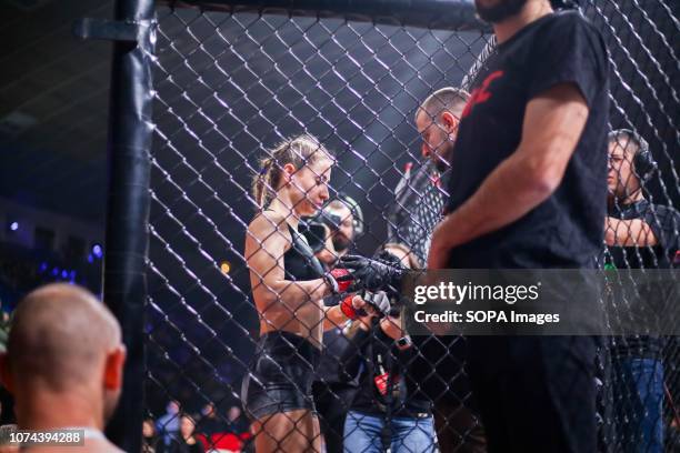 Dimitroula Hara, competitor from Greece is entering the cage while the judge check her before starting the competition during the WWFC 13 in Kiev.