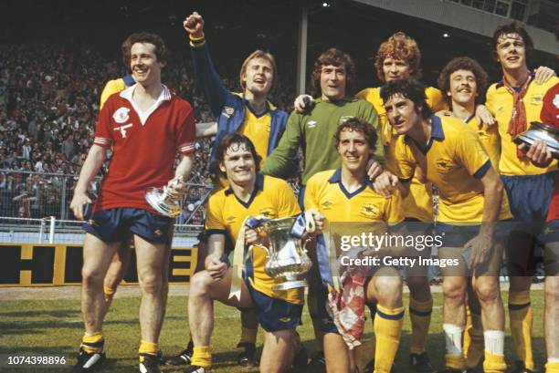 Arsenal player Liam Brady wearing a Manchester United shirt leads the celebrations after their 3-2 victory in the 1979 FA Cup Final at Wembley...