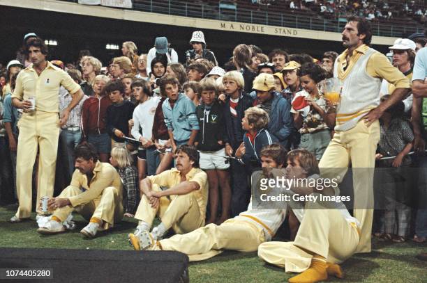 Australia bowler Dennis Lillee holding a jug of Orange Juice David Hookes Kepler Wessels Bruce Laird Rod Marsh and Len Pascoe standing, react after...