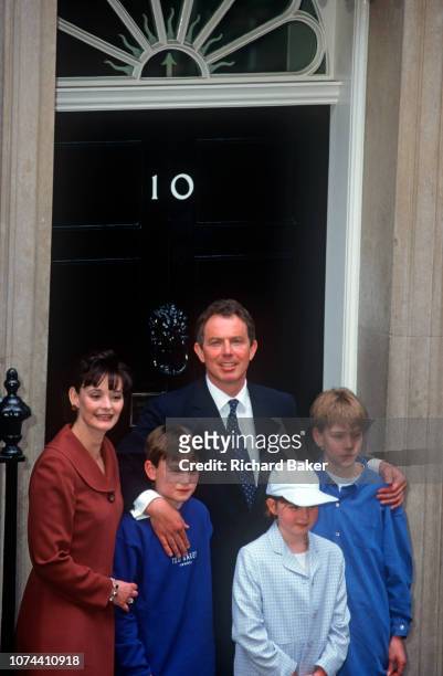 The newly-elected British Labour Prime Minister Tony Blair stands on the steps of Number 10 Downing Street with his wife Cherie and three children...
