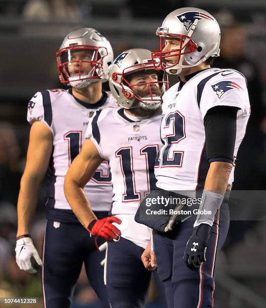 From left, New England Patriots wide receiver Chris Hogan, wide receiver Julian Edelman and quarterback Tom Brady stand on the field. The New England...