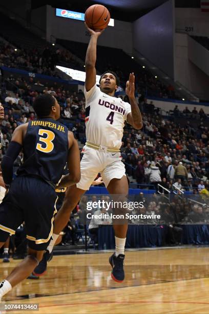 UConn Huskies guard Jalen Adams shoots while Drexel Dragons guard Troy Harper defends during the game as the Drexel Dragons take on the UConn Huskies...