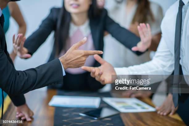 asian women mediating disagreement - fighting stock pictures, royalty-free photos & images
