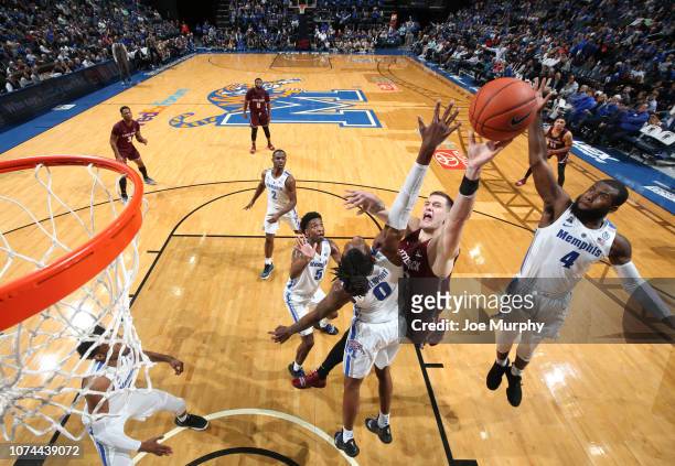 Nikola Maric of the Arkansas-Little Rock Trojans drives to the basket against Kyvon Davenport and Raynere Thornton of the Memphis Tigers on December...
