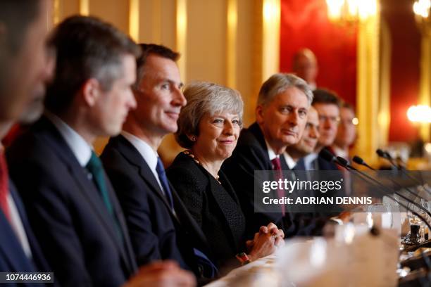 Britain's Prime Minister Theresa May sits with members of her Cabinet, including Britain's Defence Secretary Gavin Williamson , Britain's Foreign...