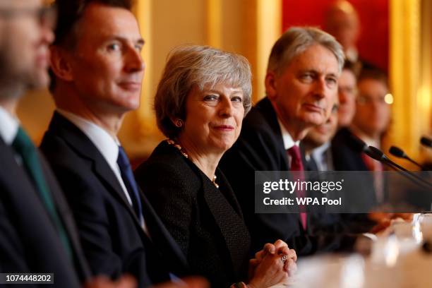 Britain's Prime Minister Theresa May sits with members of her Cabinet, including Britain's Defence Secretary Gavin Williamson , Britain's Foreign...